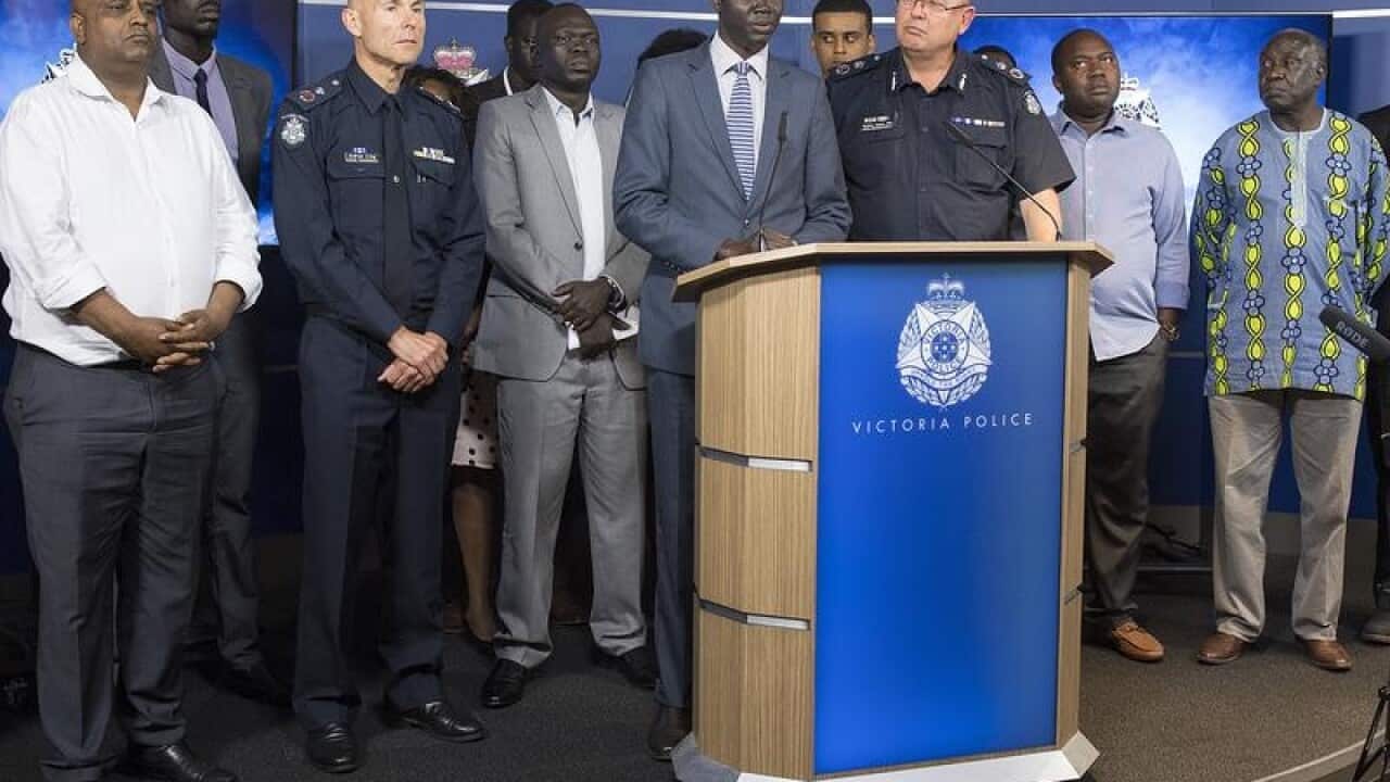 An African community leaders speaks to the media.