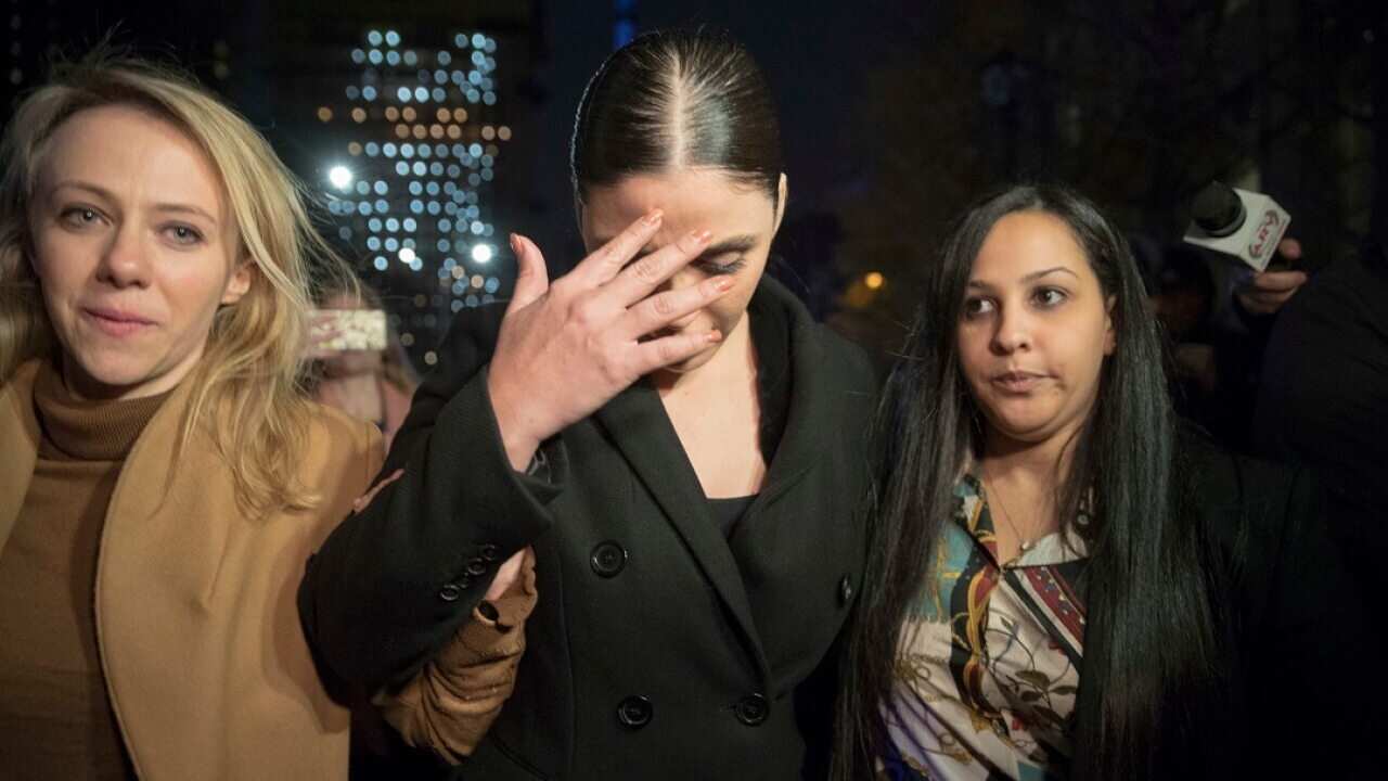 Emma Coronel, center, the wife of Joaquin "El Chapo" Guzman leaves Brooklyn Federal court after opening arguments in the trial of the Mexican drug lord known as "El Chapo," Tuesday, Nov. 13, 2018, in New York. (AP Photo/Mary Altaffer)
