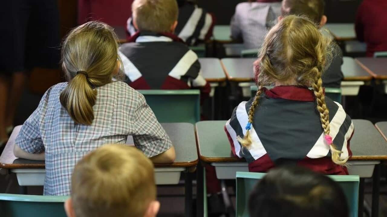 Children sit in a classroom