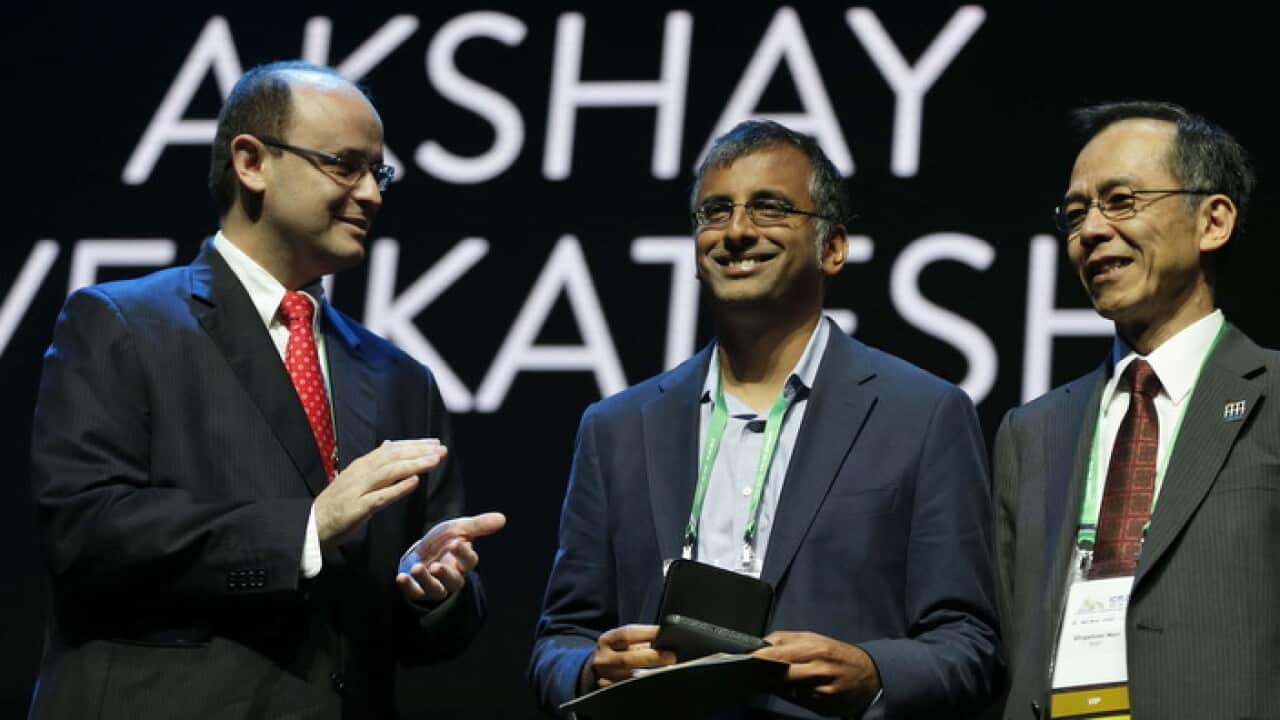 Professor Akshay Venkatesh, centre, receives the Fields Medal in Rio de Janeiro (AAP)