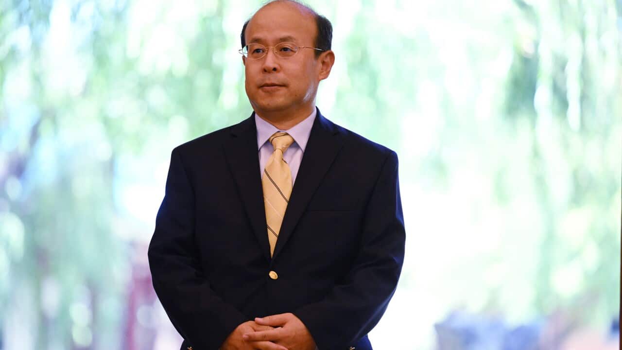 Chinese ambassador to Australia Xiao Qian wearing a suit
