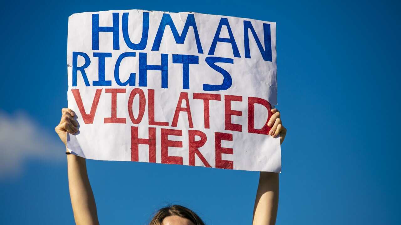 A refugee rights protester at the Kangaroo Point Central Hotel in Brisbane, Sunday, June 21, 2020.