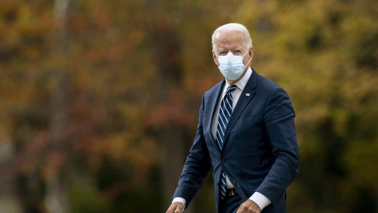 Democratic presidential candidate former Vice President Joe Biden looks to supporters and members of the press while arriving to a campaign event Friday, Oct. 16. 2020 in Southfield, Mich. (Nicole Hester/Ann Arbor News via AP)