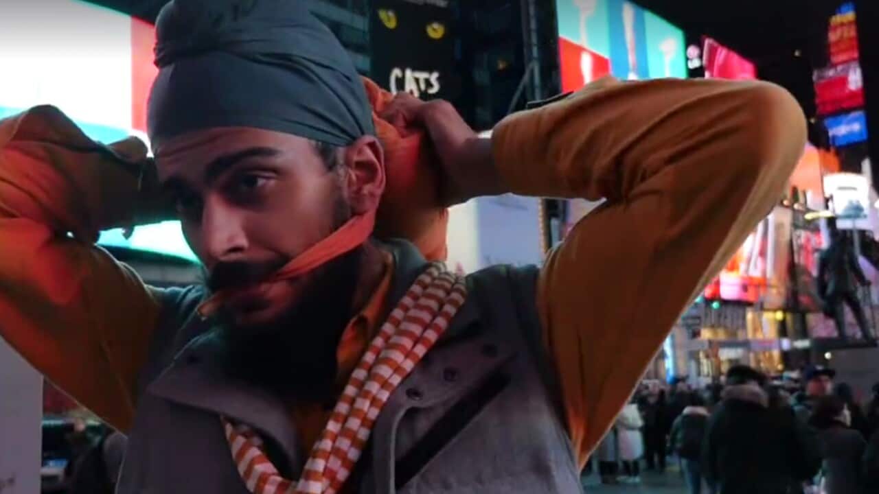Angad Singh ties his turban in the middle of Times Square to help educate people about diversity as a means of fighting hate crime