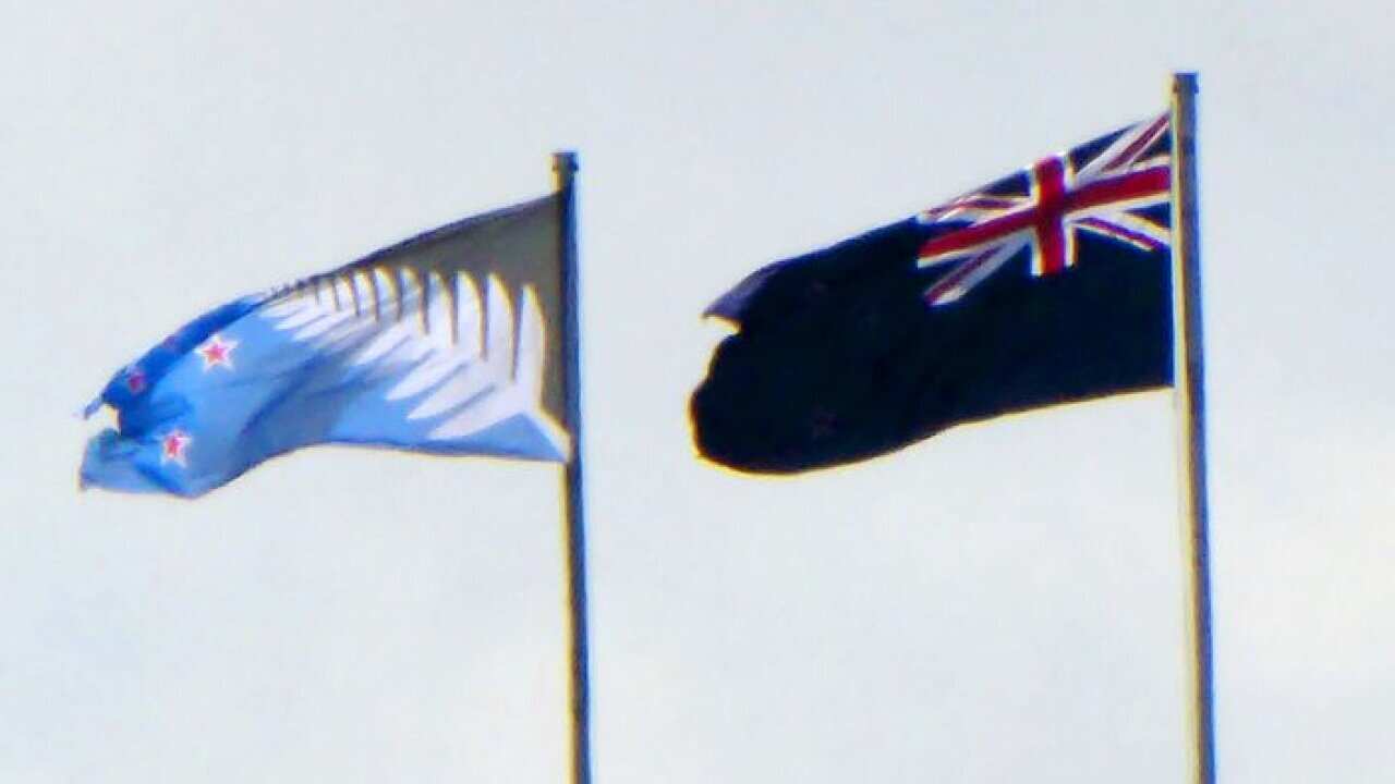 Photo taken in February 2016 shows the current New Zealand flag (R) and the proposed new design flying over a bridge in Auckland. New Zealanders began voting on March 3 on whether to adopt the new flag in a referendum which Prime Minister John Key has des