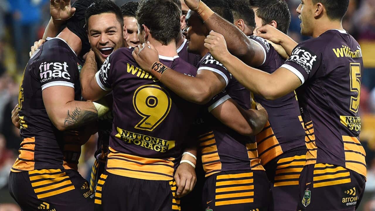 Brisbane Broncos players celebrate after scoring a try
