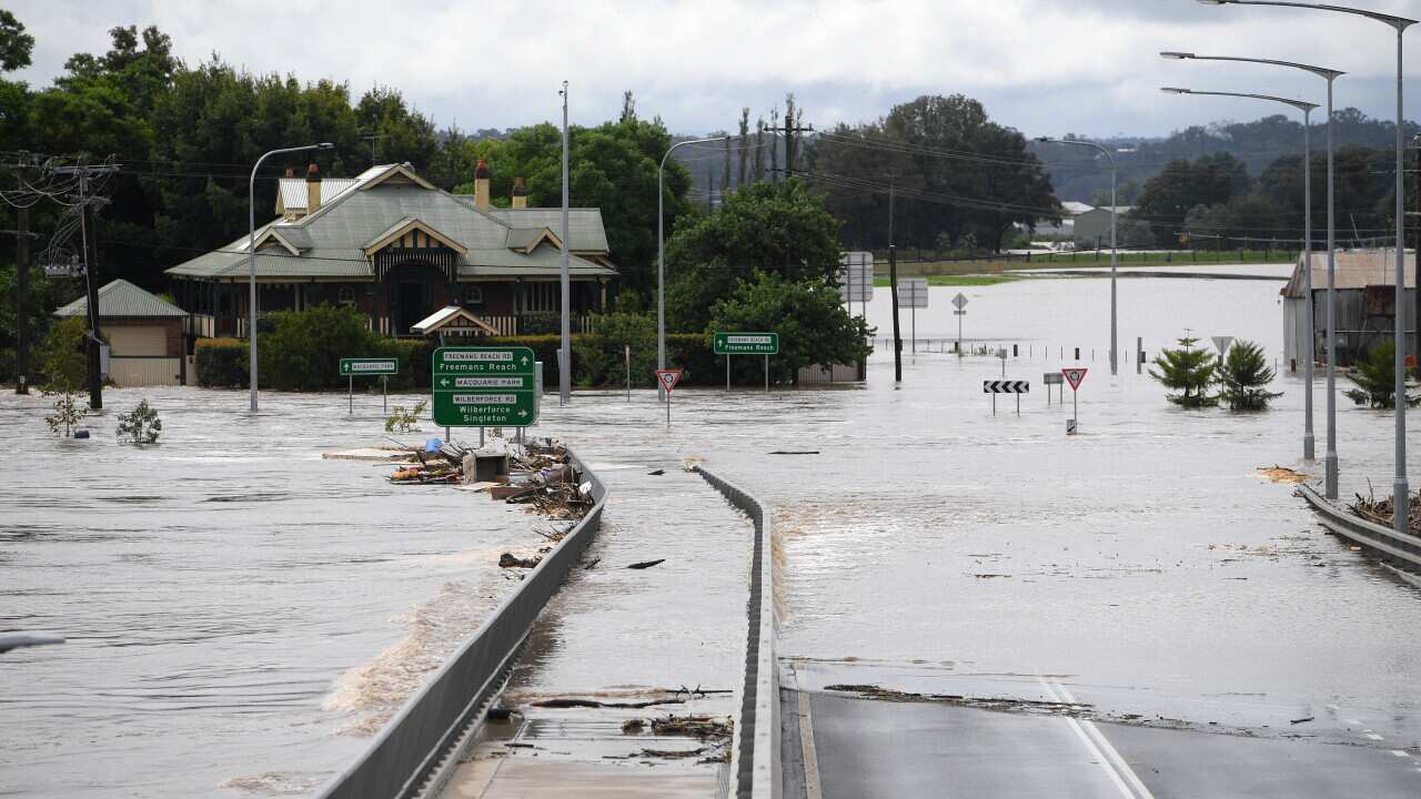 Debris carried by floodwater in the swollen Hawkesbury river is seen inundating the partially submerged Windsor Bridge, at Windsor, north west of Sydney.