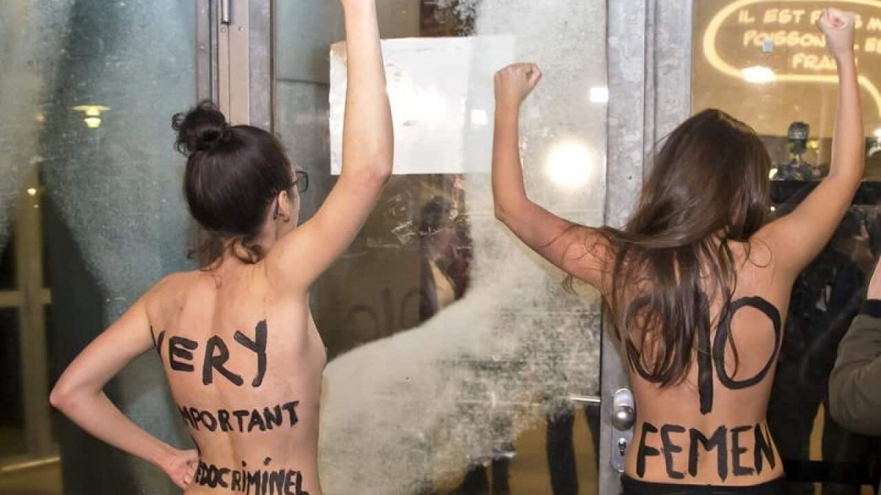 Femen activists protest outside a film retrospective to Roman Polanski
