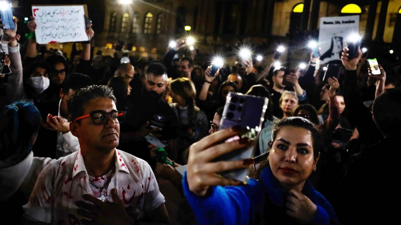 Protesters hold a vigil for 22-year-old Mahsa Amini at Sydney Town Hall