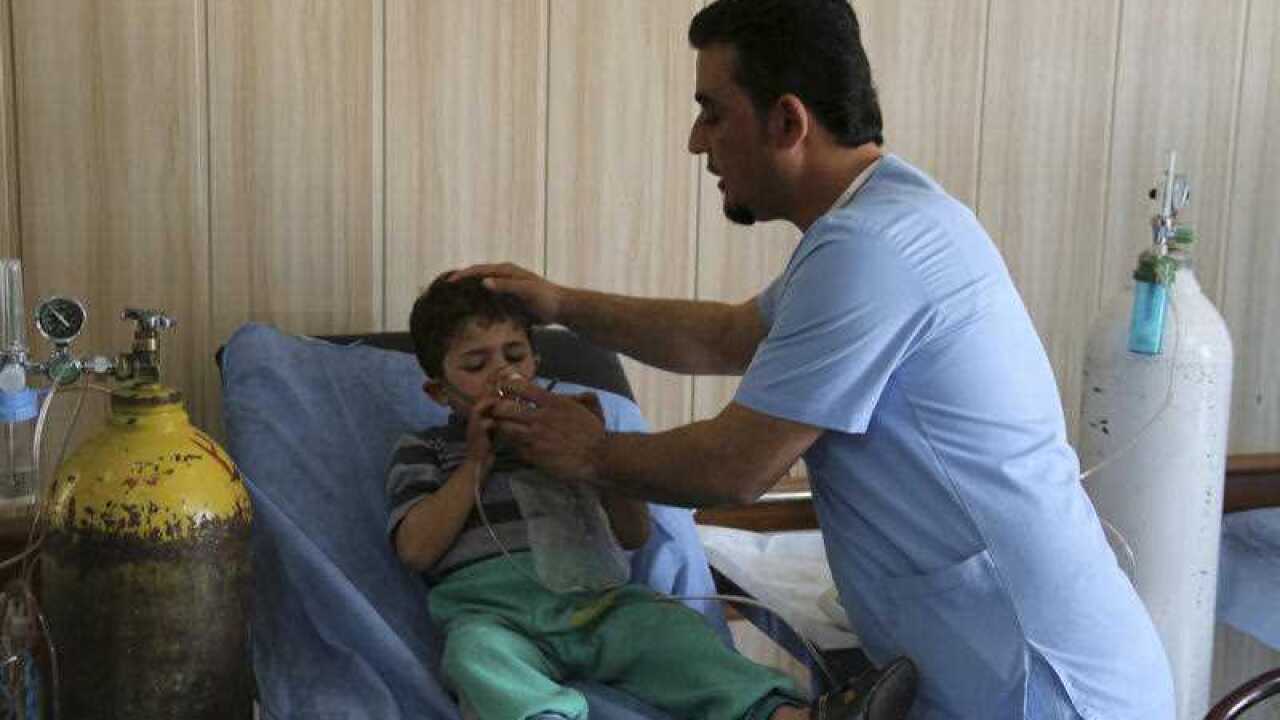 Mohammed Hussein, 3, a victim exposed to a chemical attack receives treatment at a hospital in Taza