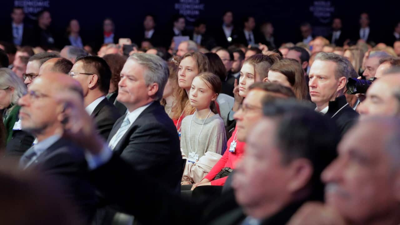 Swedish environmental activist Greta Thunberg listens as US President Donald Trump addresses the World Economic Forum in Davos.