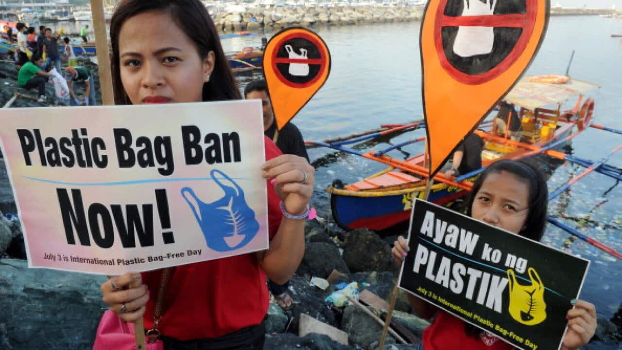 Environmental activists and volunteers hold placards calling for a ban of the use of plastic bags in Manila (JAY DIRECTO/AFP/Getty Images)