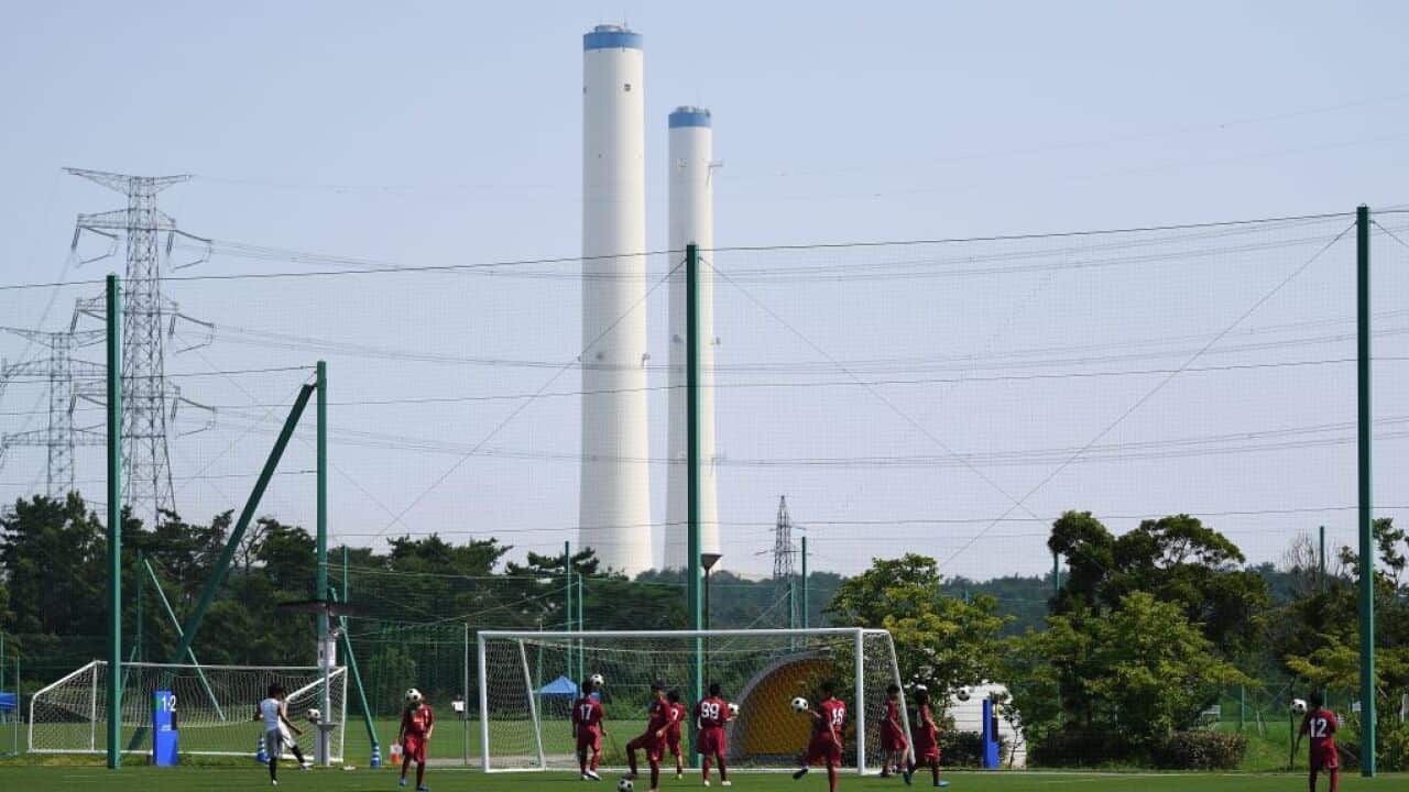 Children play football at the J-Village during a media tour in Naraha, Fukushima prefecture on August 2, 2019.