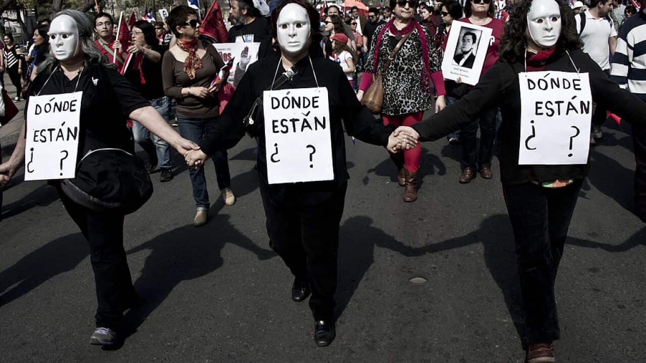 Chilean protestors hold signs reading "Where are they?"