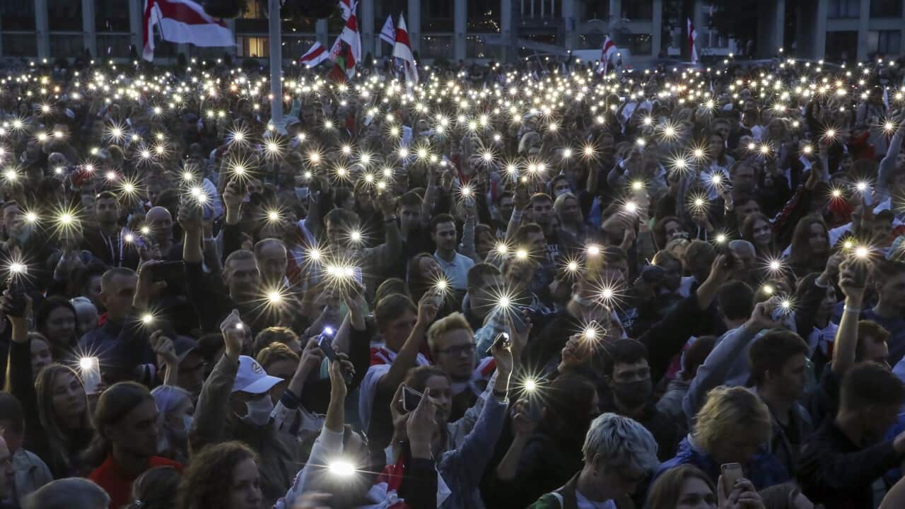 People use their mobile phone torches during an opposition rally in Independence Square in Minsk