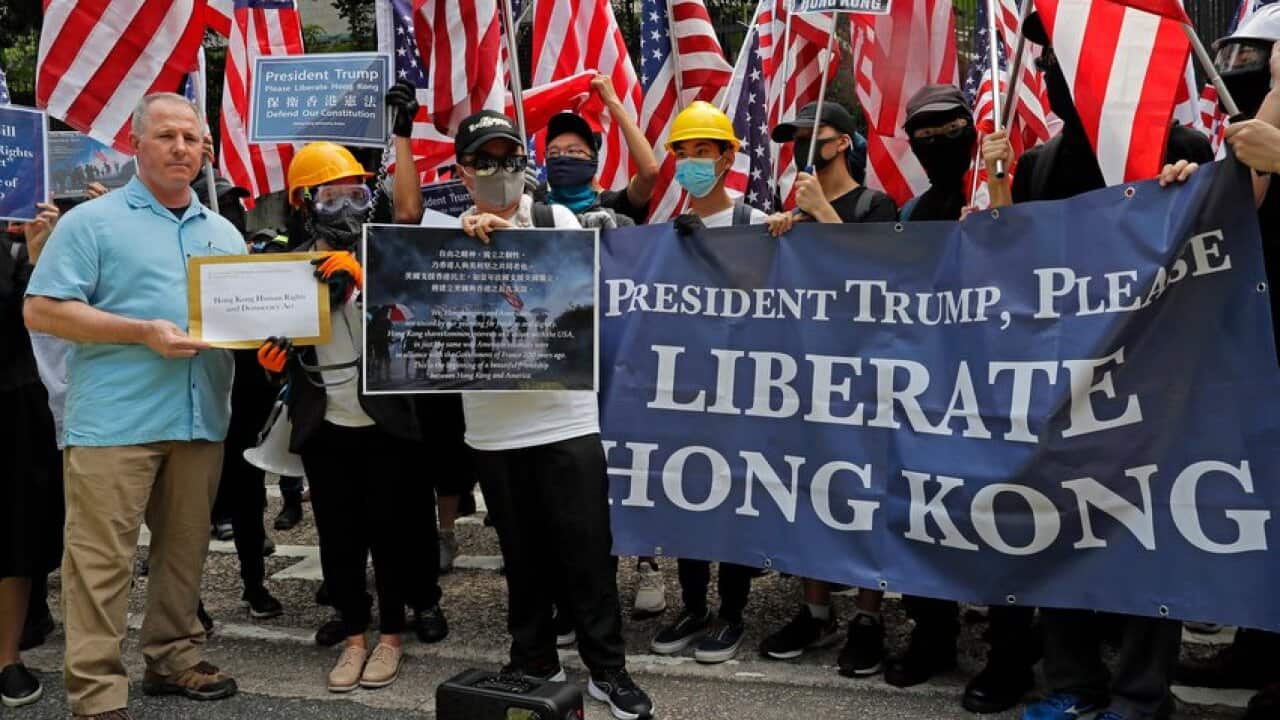 Thousands of Hong Kong demonstrators marched to the U.S. Consulate on Sunday, urging President Donald Trump to help "liberate" their city.