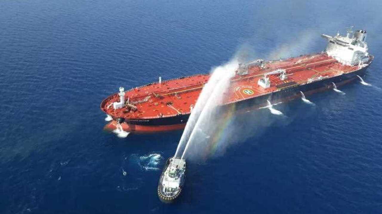 An Iranian navy boat try to control a fire on the crude oil tanker Front Altair in the Gulf of Oman, 13 June 2019.