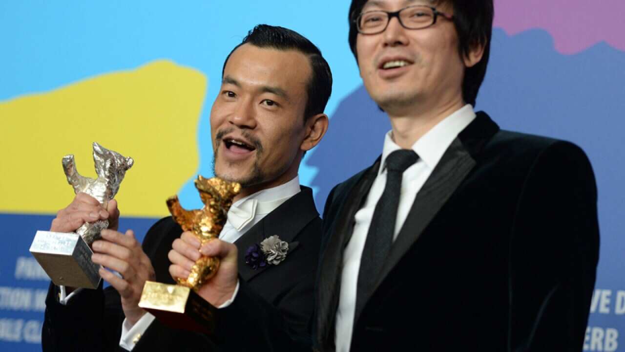Chinese director Yinan Diao (R) with the Golden Bear award