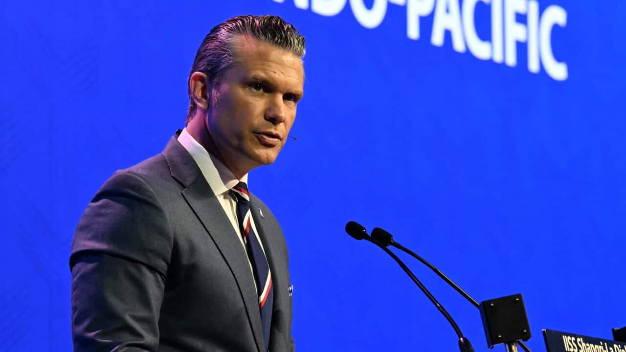 A man standing at a podium and speaking into a microphone.
