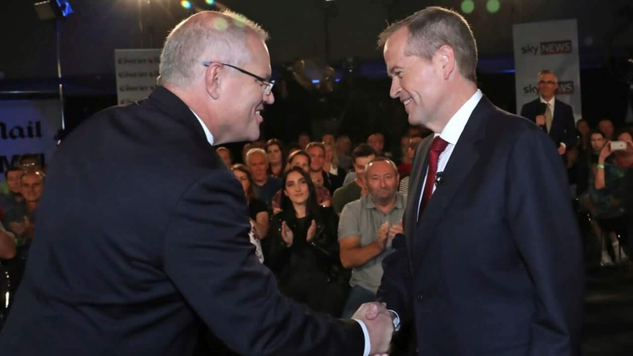 Australian Prime Minister Scott Morrison, left, and opposition leader Bill Shorten shake hands before the Sky News/Courier Mail People's Forum in Brisbane,