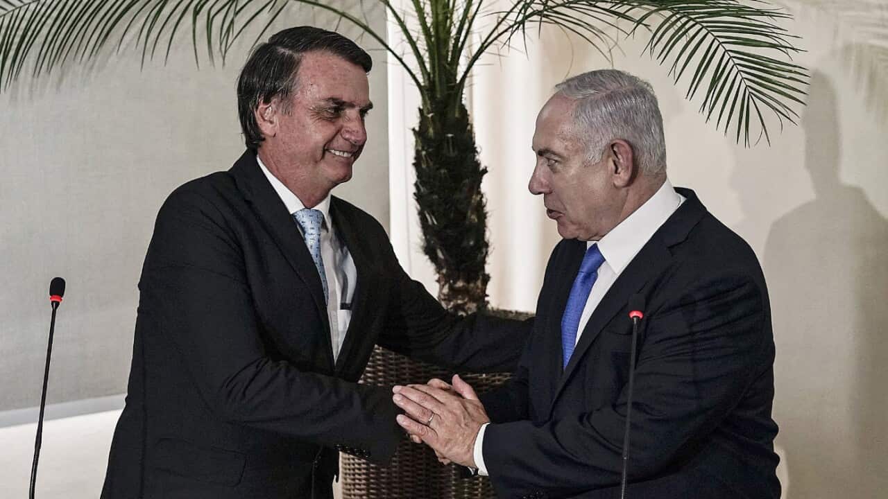 Brazilian President-elect Jair Bolsonaro (L) and Israel's Prime Minister Benjamin Netanyahu (R) shake hands.