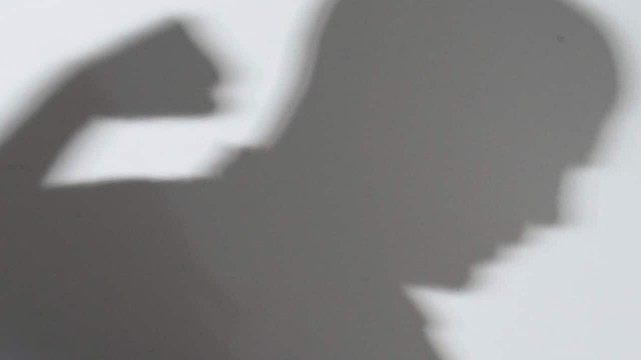 A shadow of a man with a clenched fist