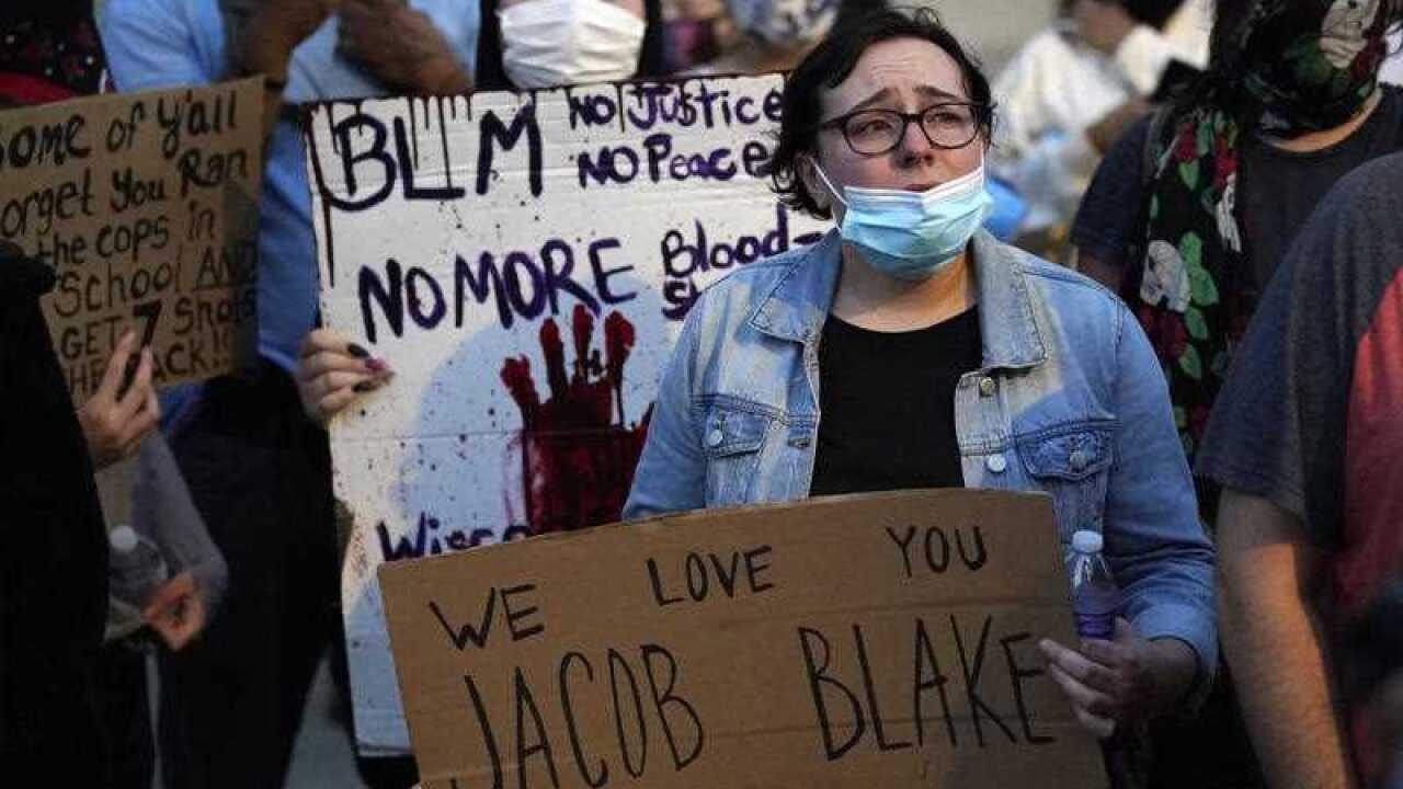 People gather to protest in Kenosha over the Sunday shooting of Jacob Blake.