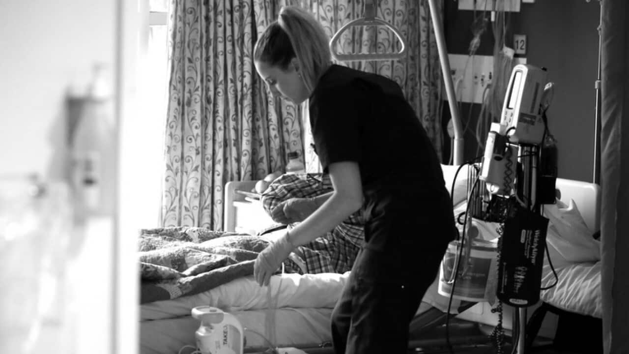 A nurse in a palliative care unit tending to a patient (AAP)