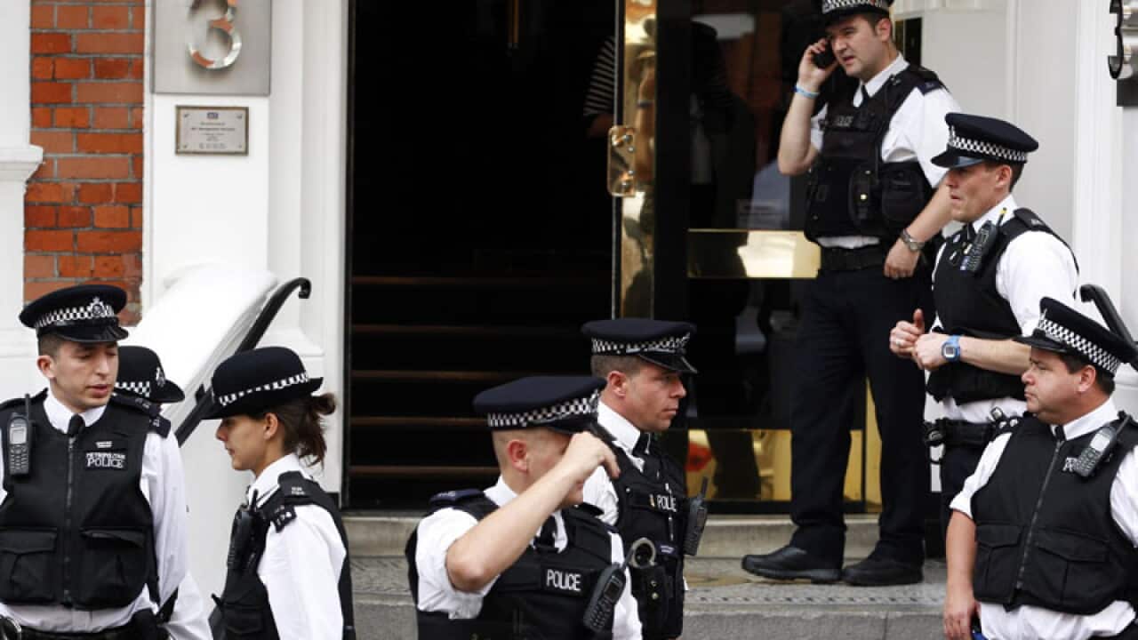 With Assange inside, UK police guard exits