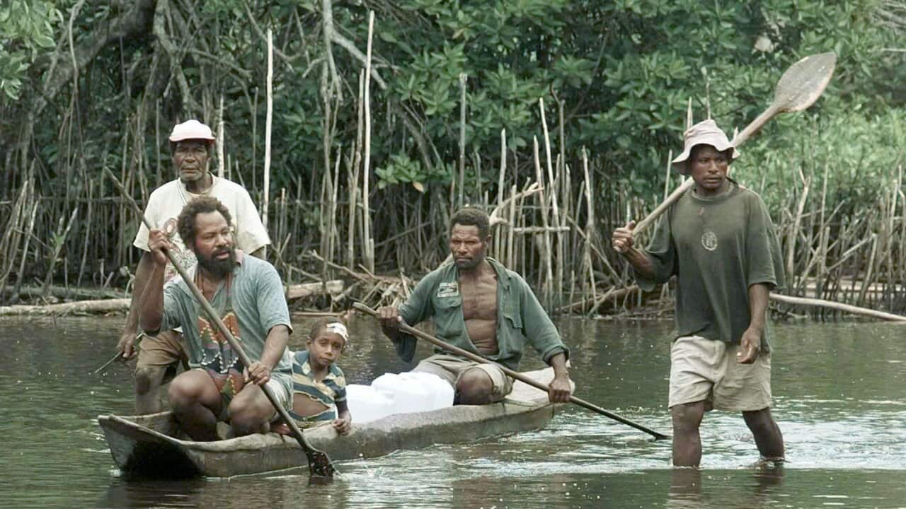 Villagers from Sissano in northern Papua, New Guinea, use a dugout canoe to bring supplies.