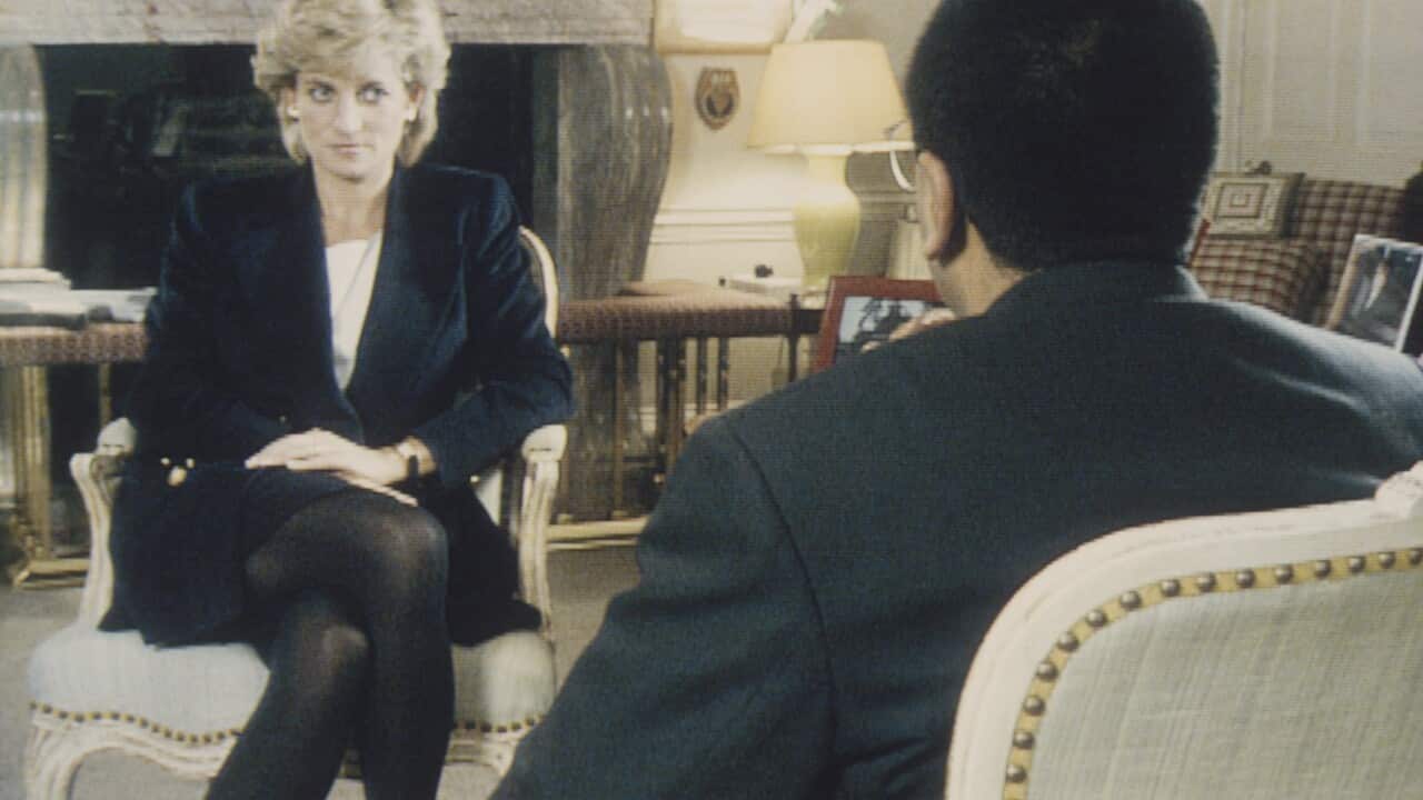 Princess Diana is seen sitting in a chair while being interviewed by a journalist.