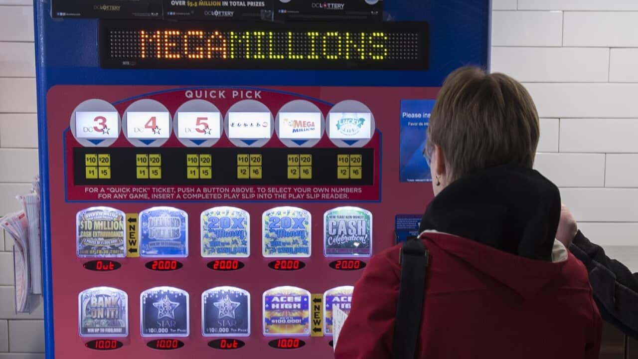 A woman buys lottery tickets from a machine in Washington as Mega Millions has a record jackpot on offer.