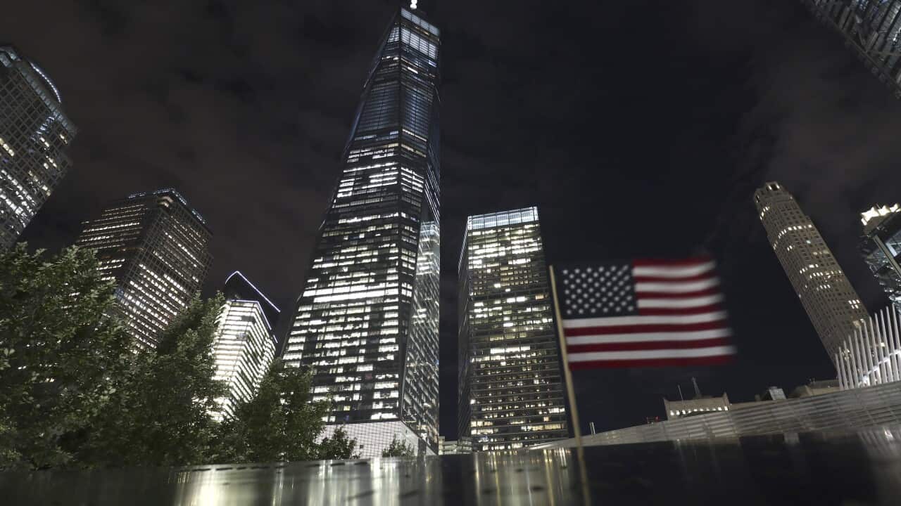 A flag flies at the south pool of the National September 11 Memorial.