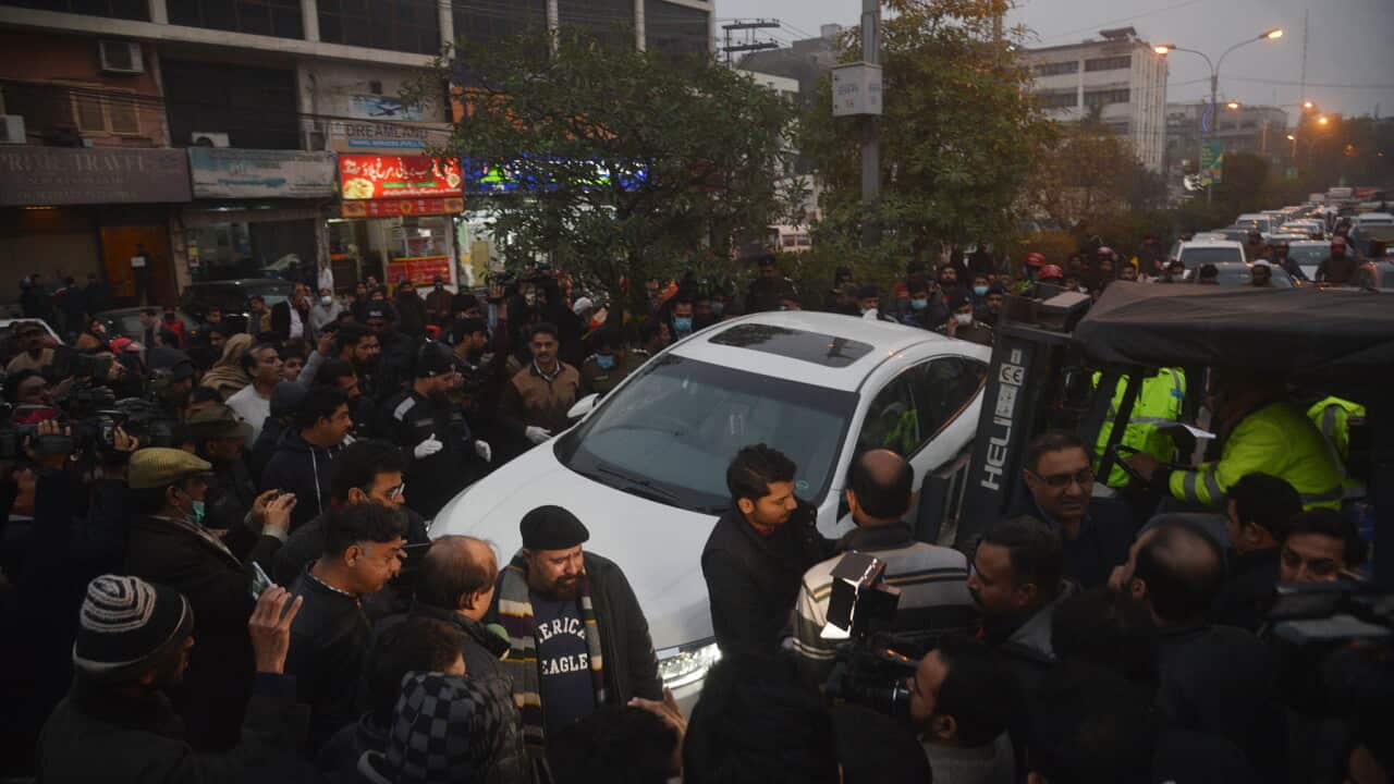 Media surround a car at the site of the Pakistan shooting (AAP).jpg