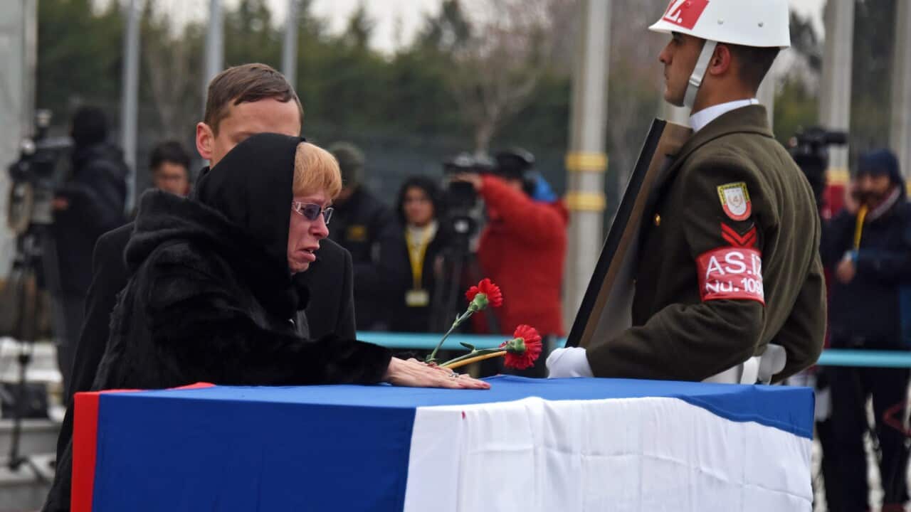 Marina Karlov (C), the wife of slain Russian ambassador to Turkey Andrey Karlov, mourns beside his coffin