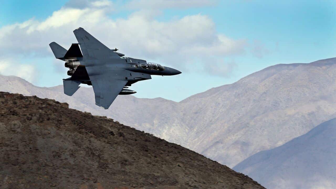 A U.S. Air Force airman pushes a cart past an F-15E Strike Eagle at Bagram Air Field in Afghanistan on Oct. 17, 2009.