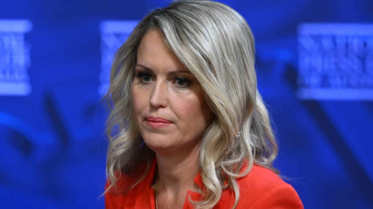 A woman wearing a red jacket