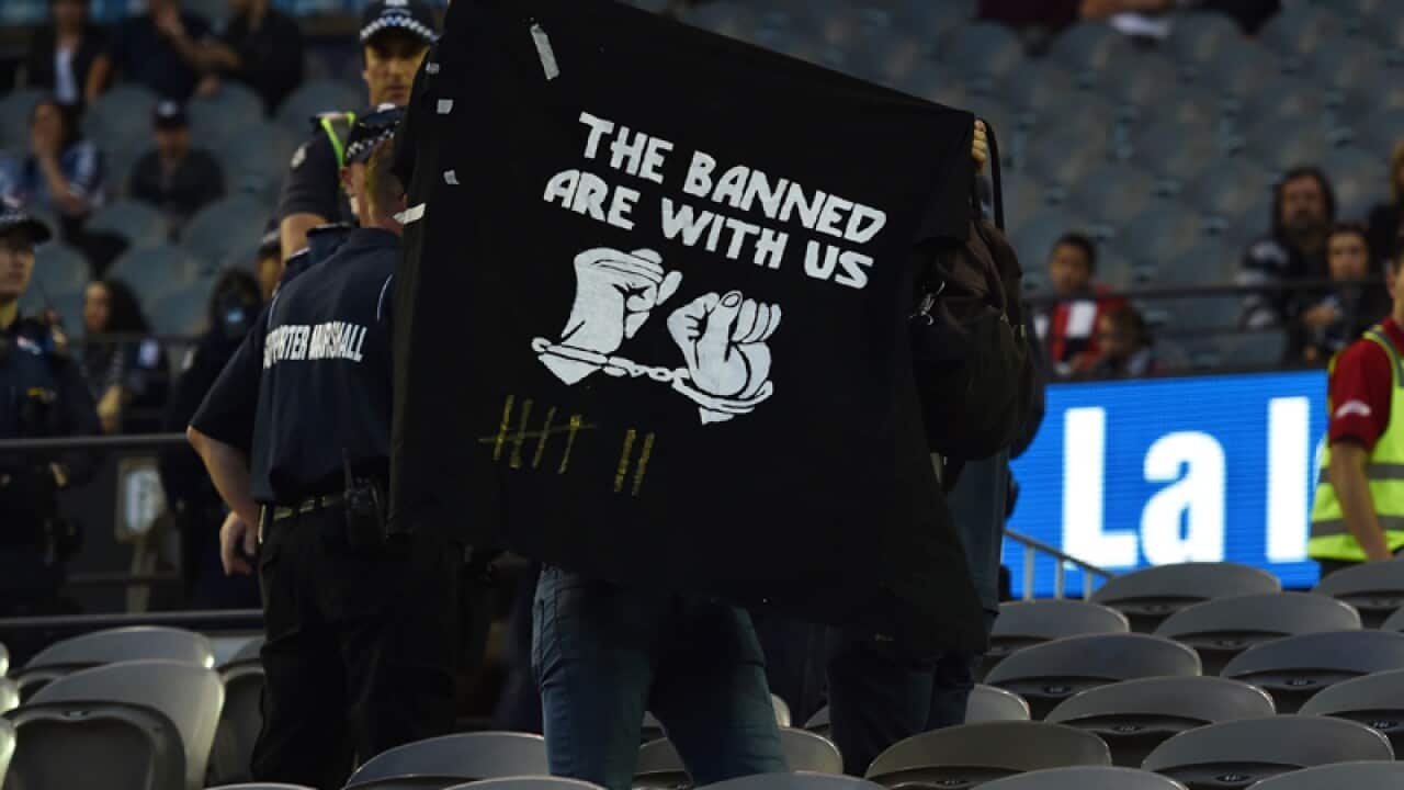 Victory fans walk out while one remains in the seats