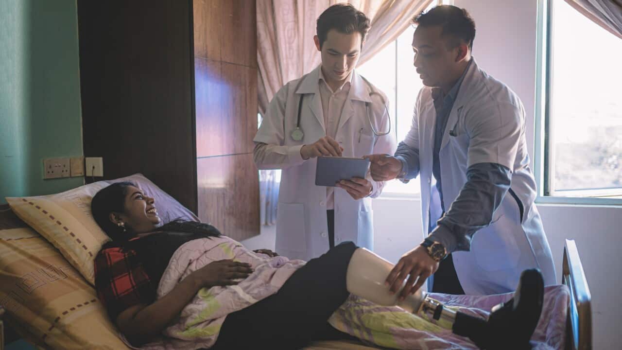 Doctors Visiting a Patient