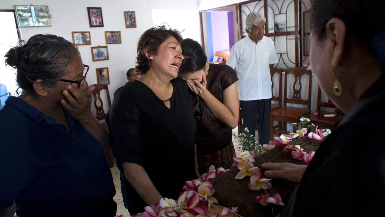 Family members grieve over the coffin containing the remains of 64-year-old Reynalda Matus during a wake, in Juchitan, Oaxaca state.