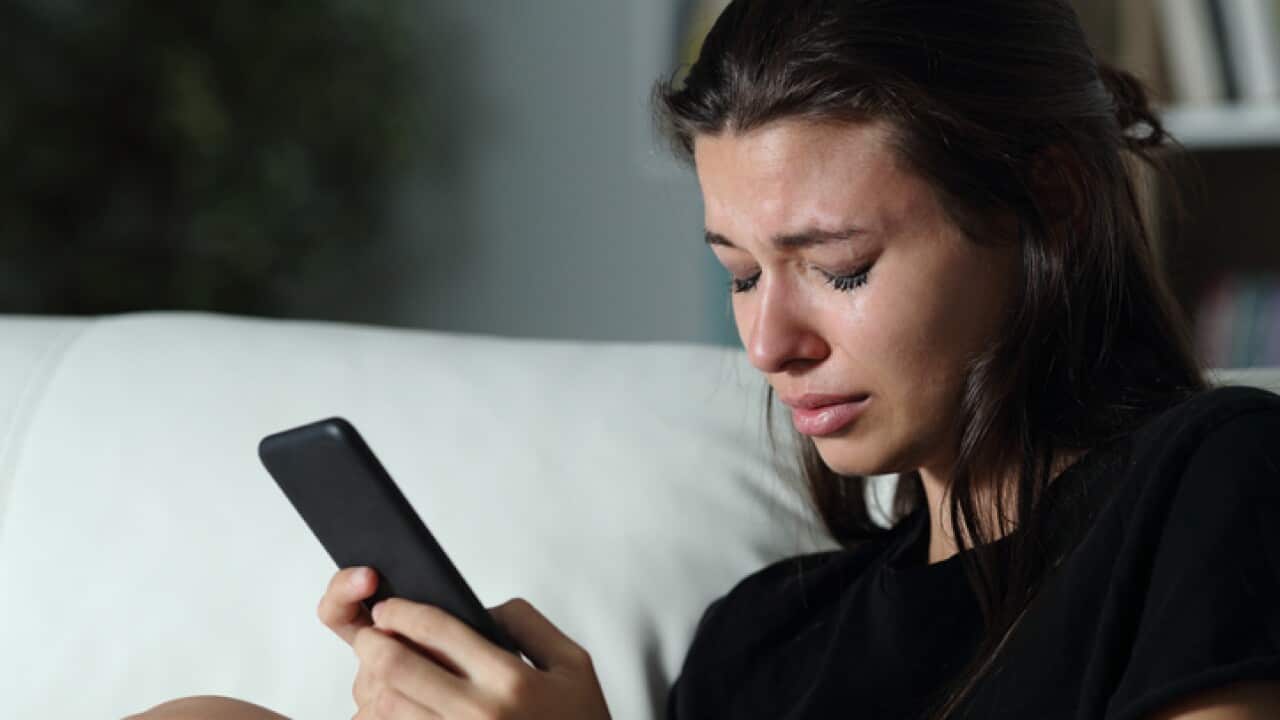Sad teen crying after read phone message