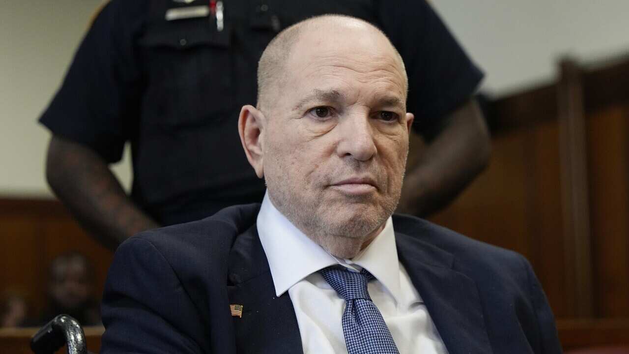 A man in a suit and tie is sitting in court.