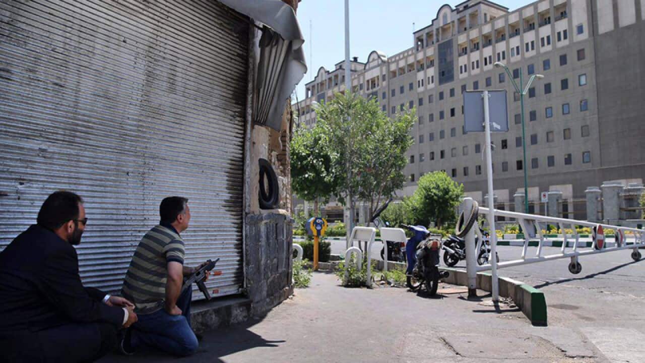 Security personnel take position in front of Iran's parliament