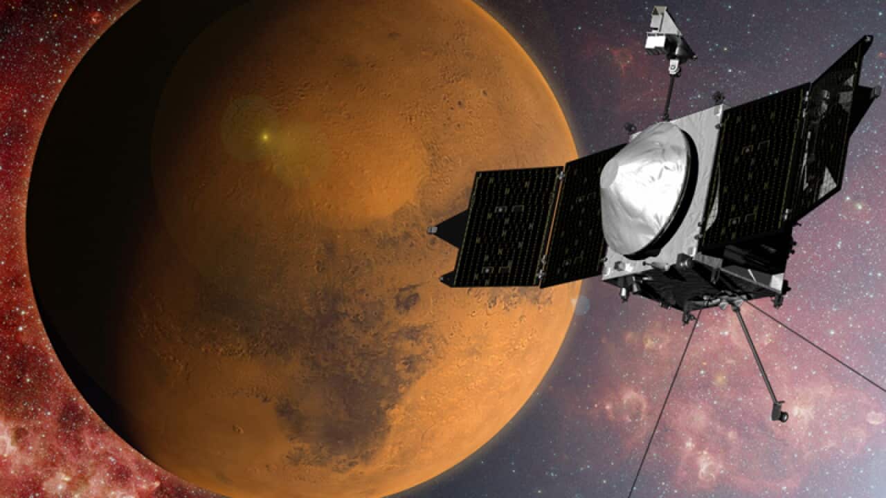 An artist concept of the MAVEN spacecraft approaching Mars