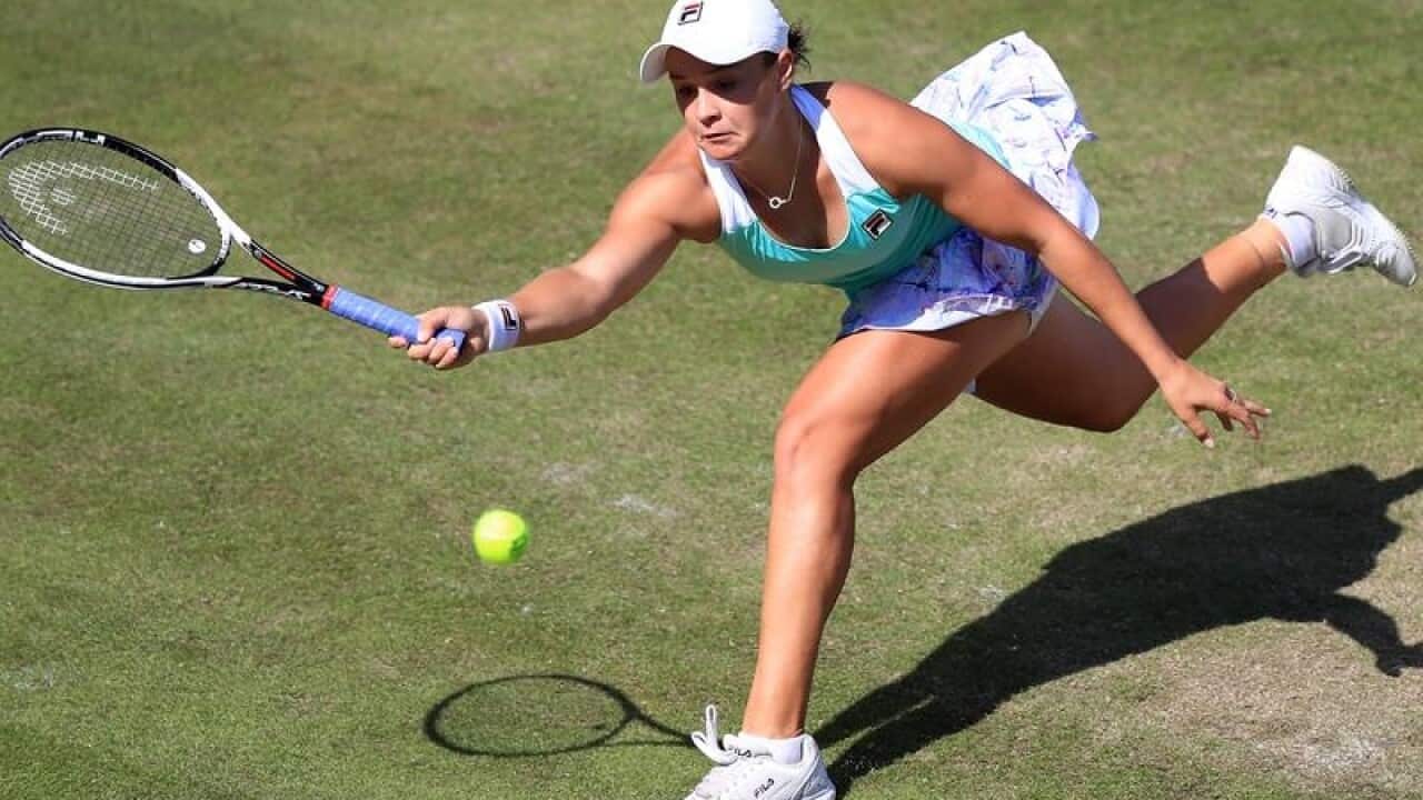 Ashleigh Barty lunges for a shot from Julia Georges