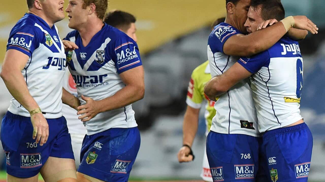 Josh Reynolds, (right), of the Bulldogs is congratulated by team mates