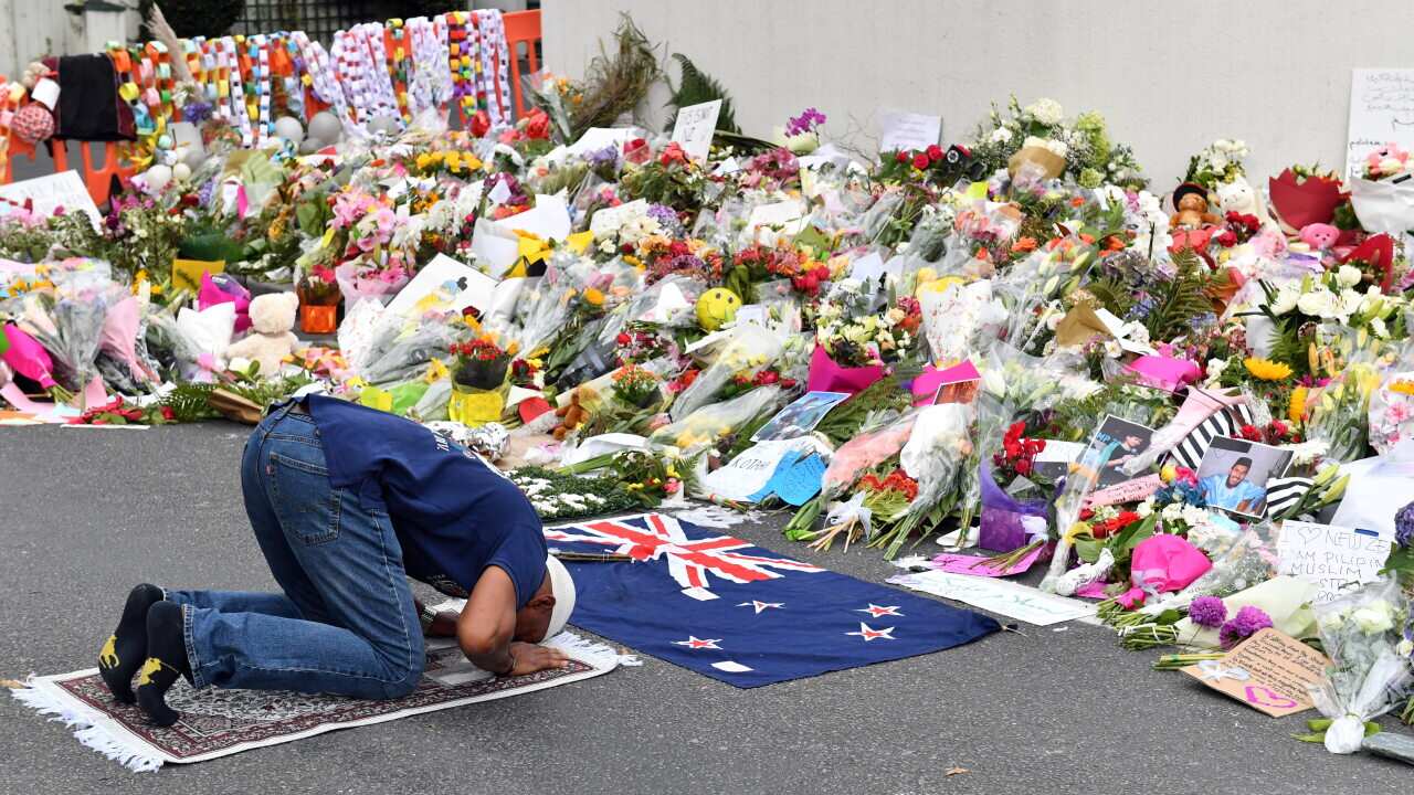 A Muslim worshipper prays at a makeshift memorial at the Al Noor Mosque in Christchurch, New Zealand, 2019.