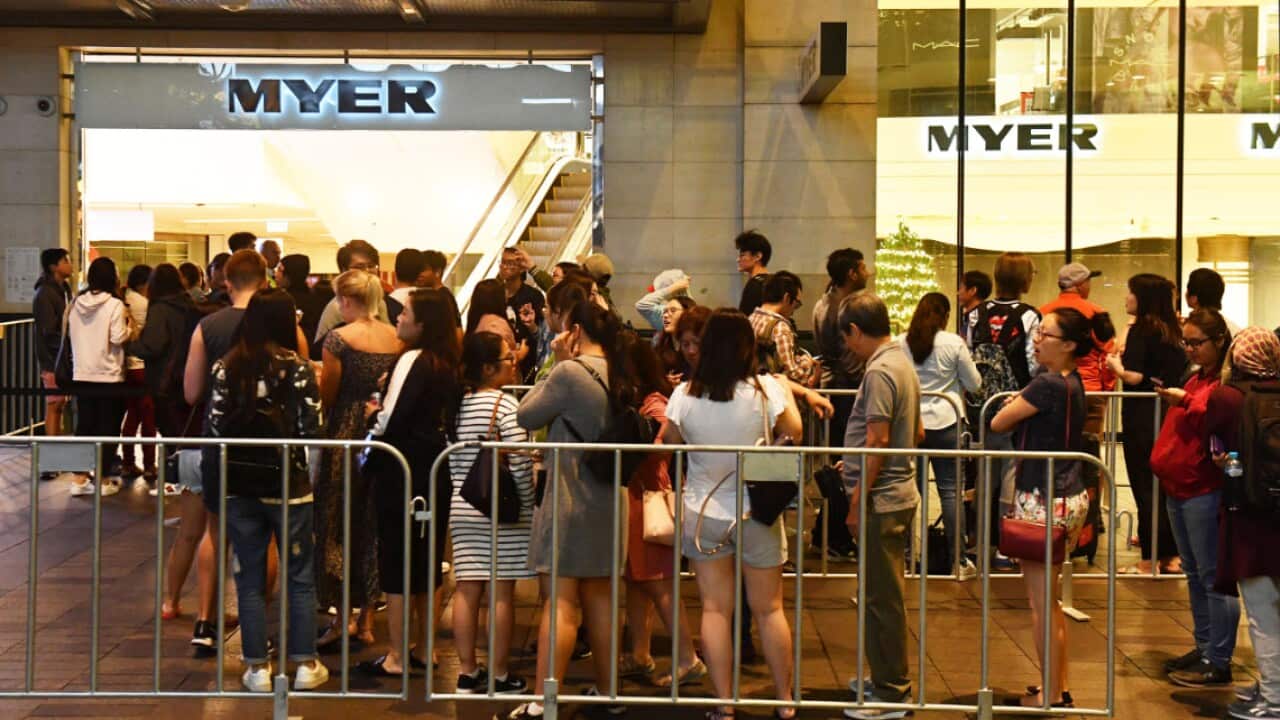 Shoppers wait outside the Myer department store for the Boxing Day sales in Sydney,