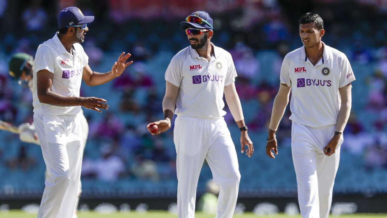 Indian bowlers Ravichandran Ashwin, left, Jasprit Bumrah and Navdeep Saini, right, talk during play on Saturday