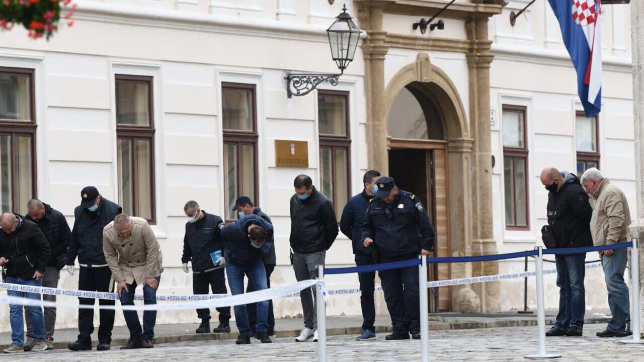 A police officers stands beside a barricade tape at st. Mark Square where a police officer was shot in Zagreb,Croatia on October 12, 2020.Police officer at a time of shooting was working as a personal protection officer for the government at St mark's Squ